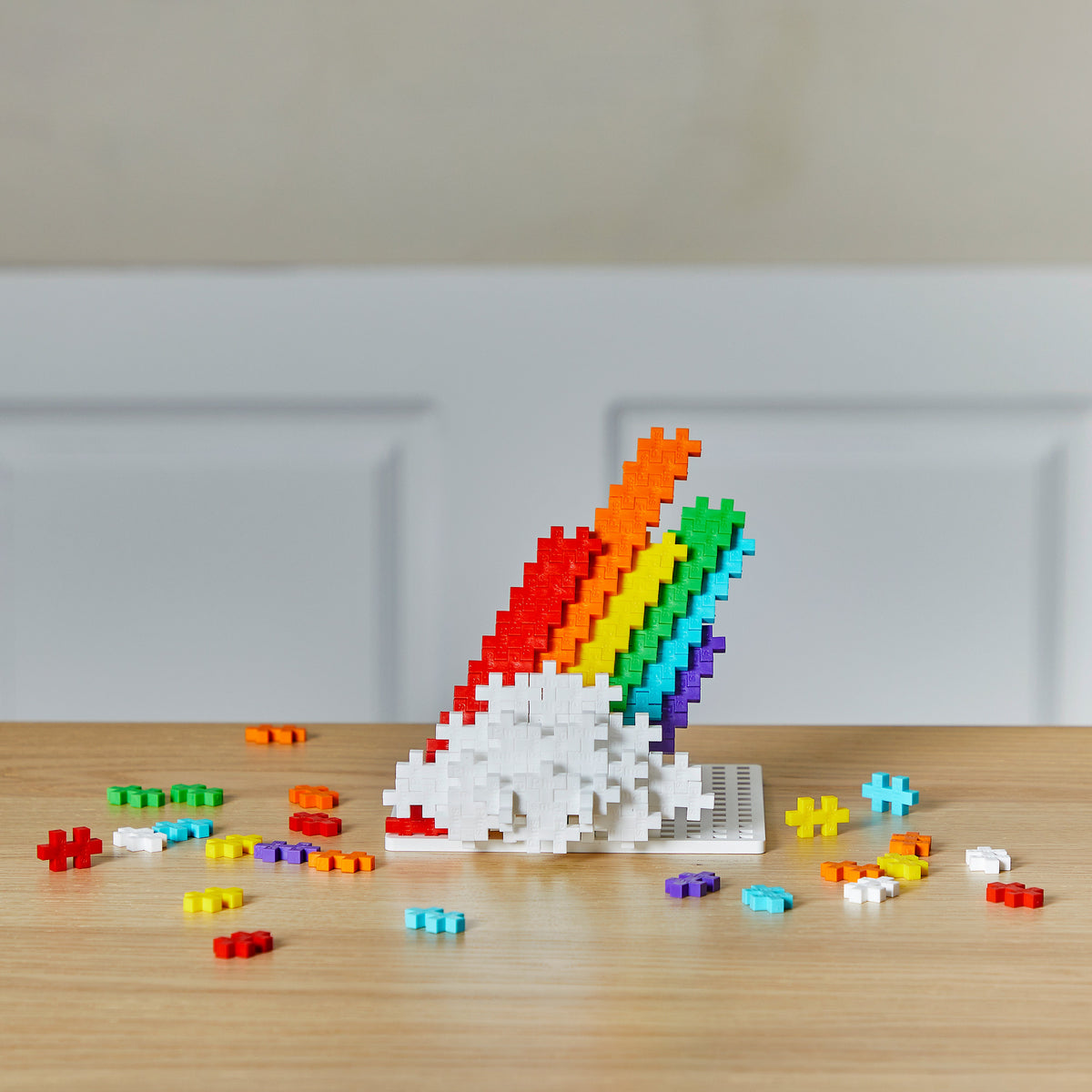 Tube - Rainbow: rainbow and cloud build on a wooden table
