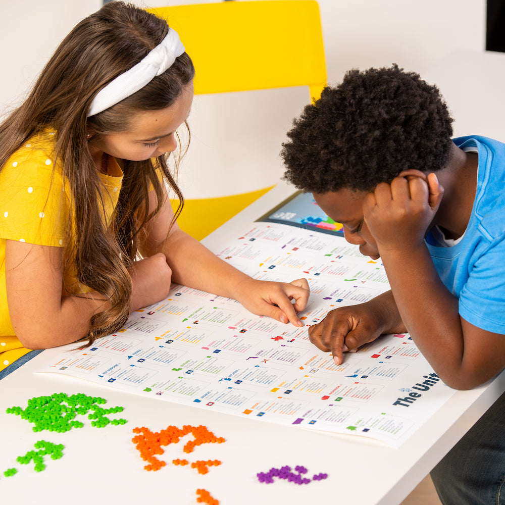 Kids building the Puzzle By Number® - 1400 pc Map of the United States at a table