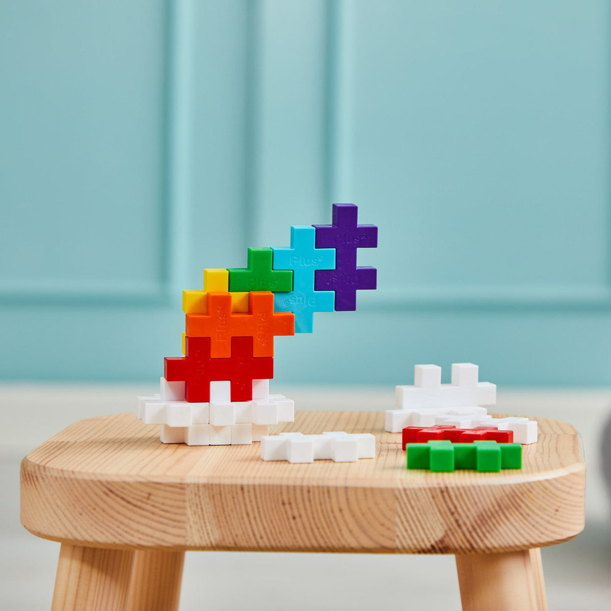 BIG Plus-Plus rainbow builds on a small wooden stool