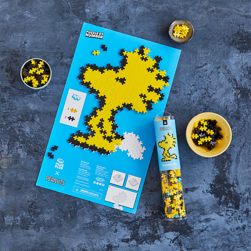 Woodstock - 275 pc Puzzle By Number®: completed Woodstock on the blue puzzle sheet with tube